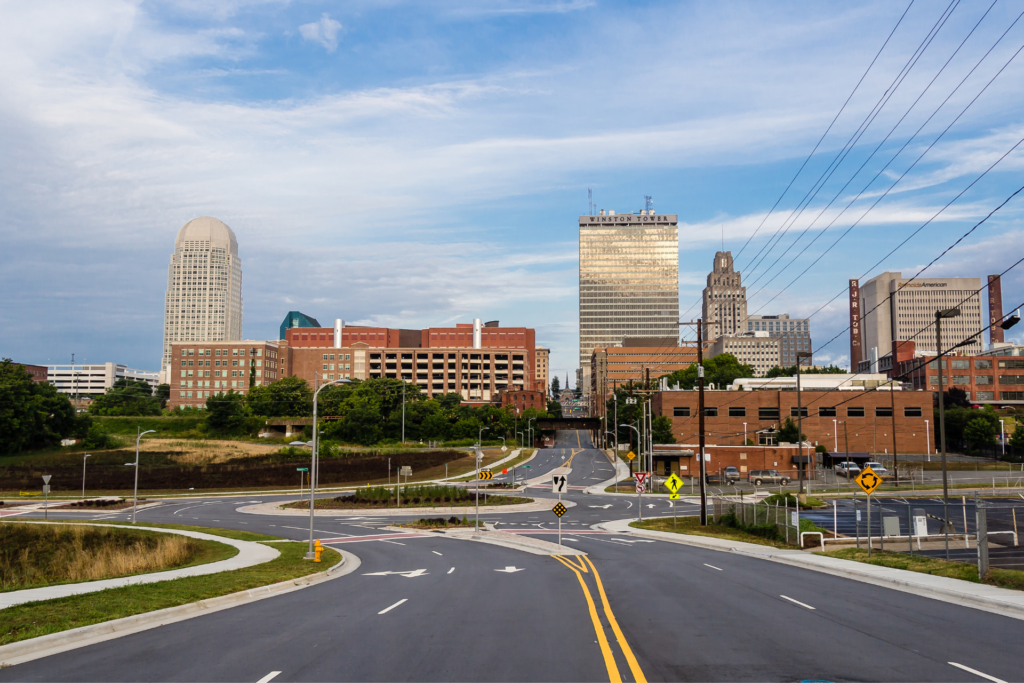 An empty street with a city in the background