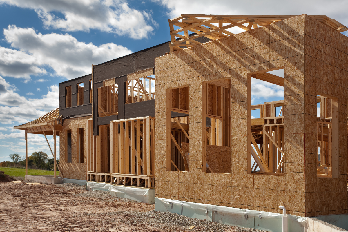 A house that is being built with a blue sky in the background