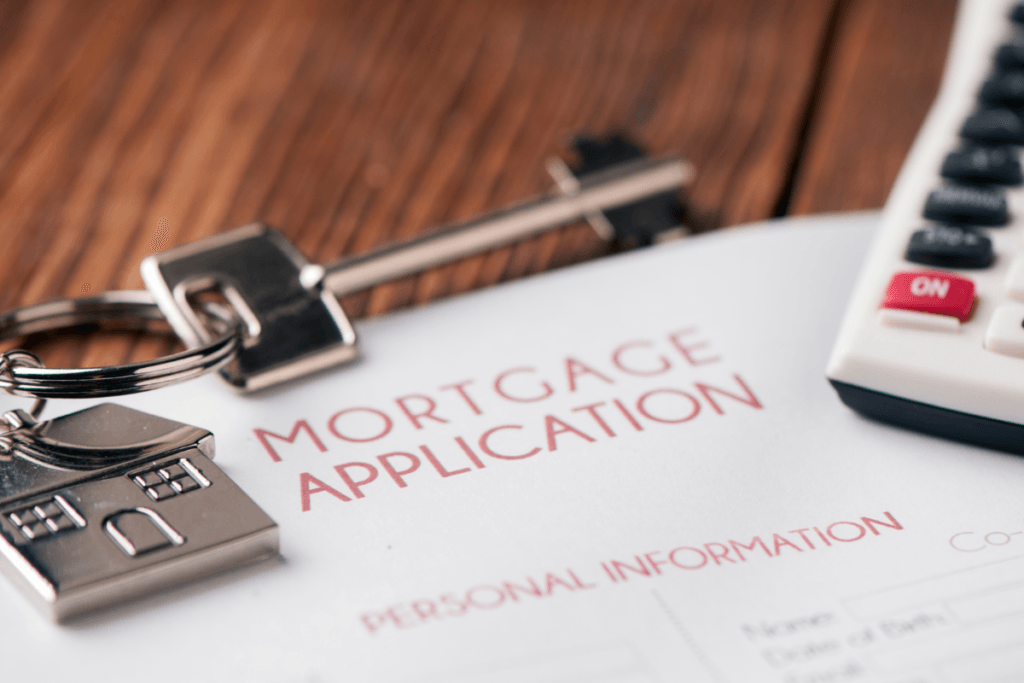 A mortgage application with keys and a calculator on it