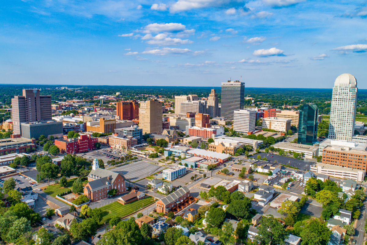 An aerial view of a city with lots of buildings and trees