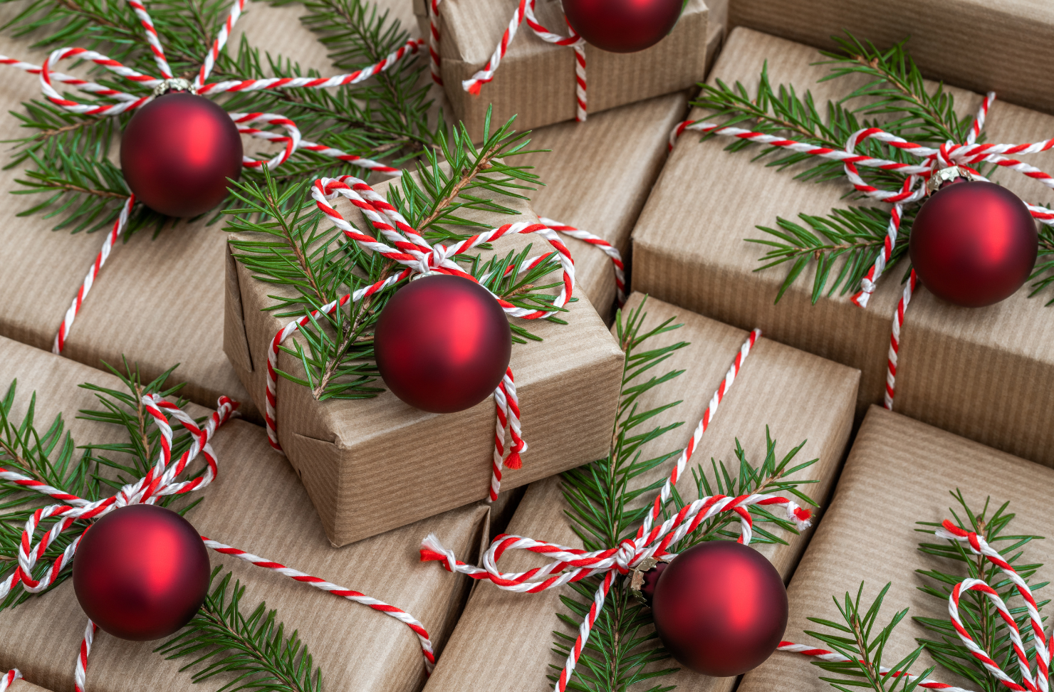 A bunch of christmas presents wrapped in brown paper