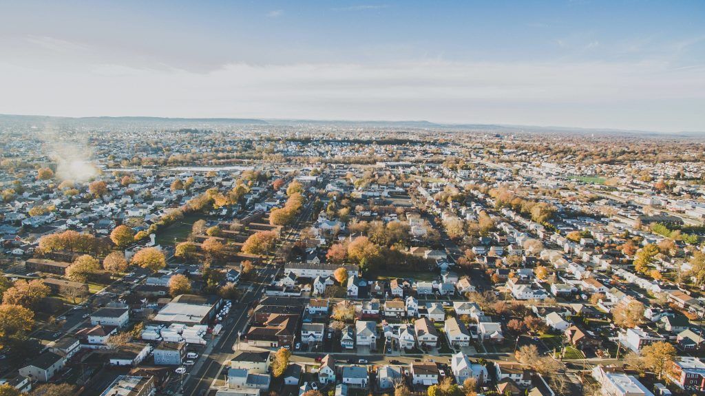 An aerial view of a city with lots of houses and trees.
