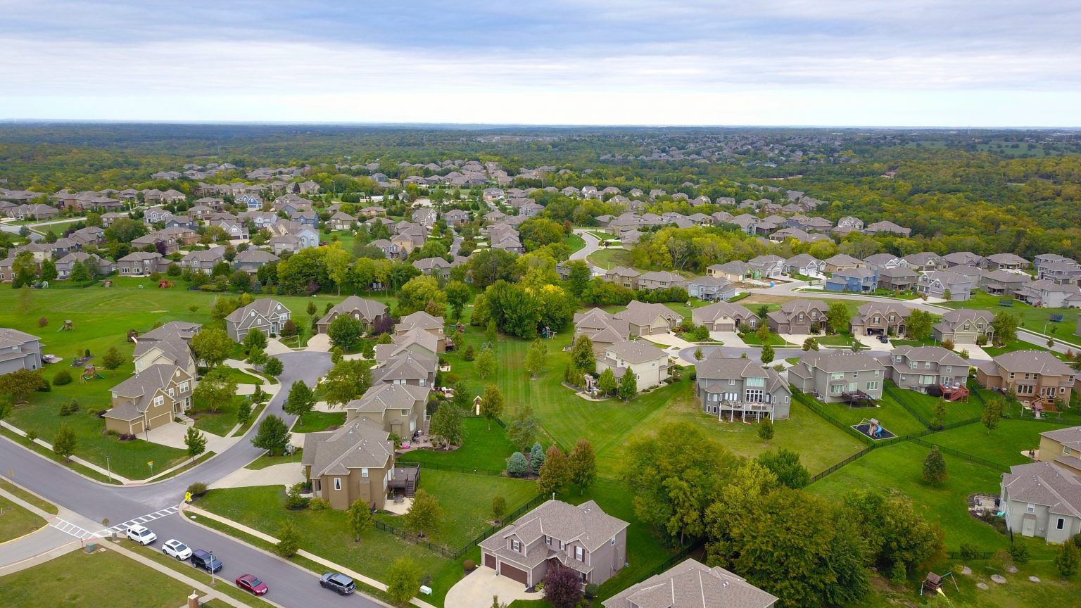 An aerial view of a residential area with lots of houses and trees