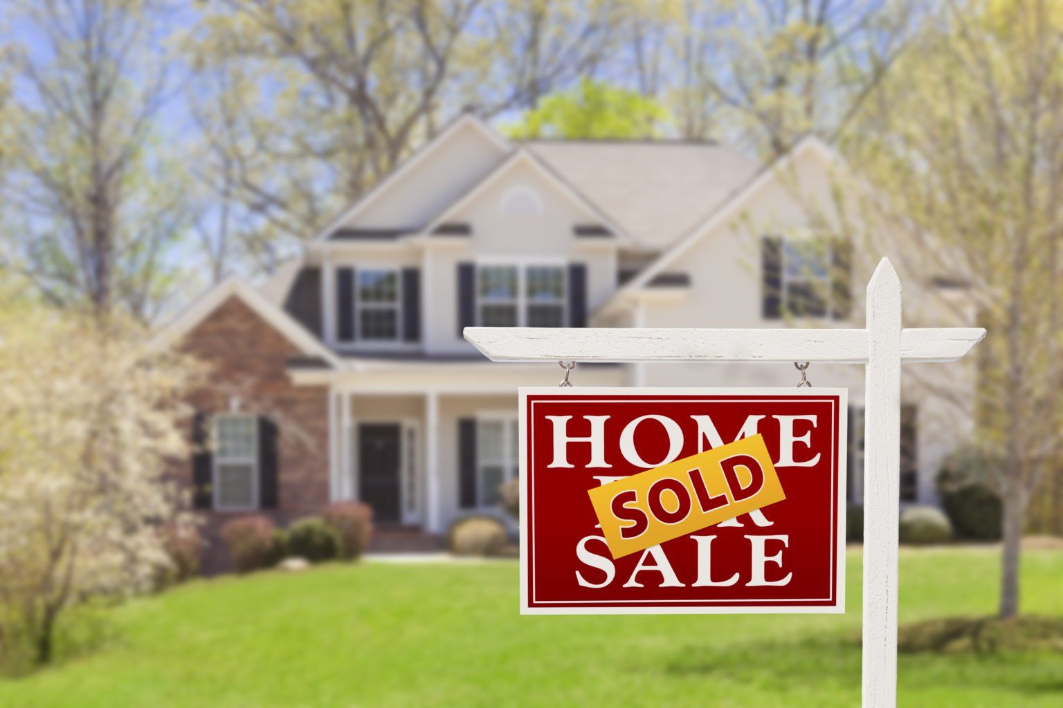 A house with a sold sign in front of it