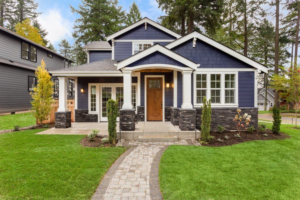 A blue house with a walkway leading to it