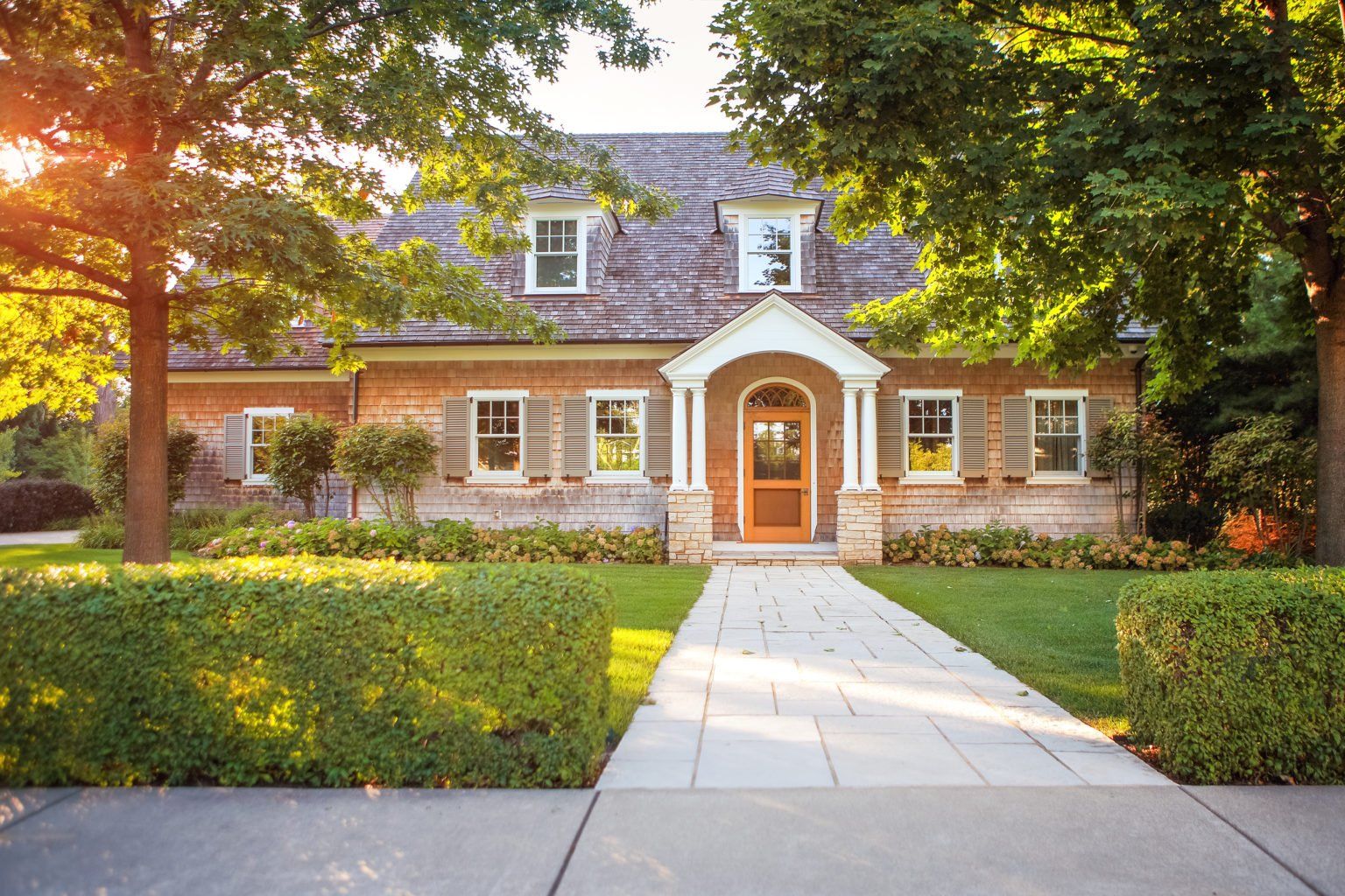A large brick house with a walkway leading to it