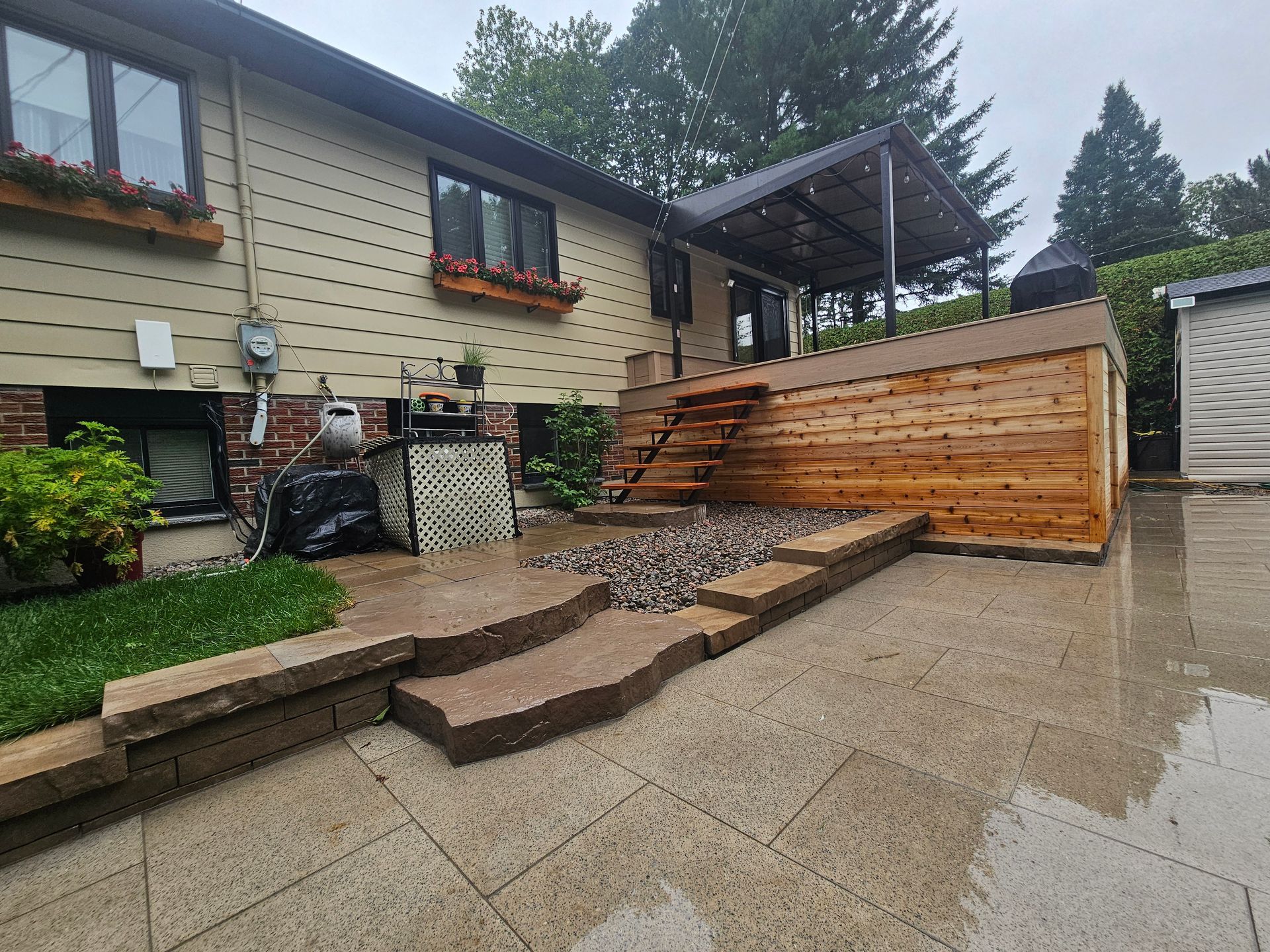 A house with a wooden deck and stairs in front of it.