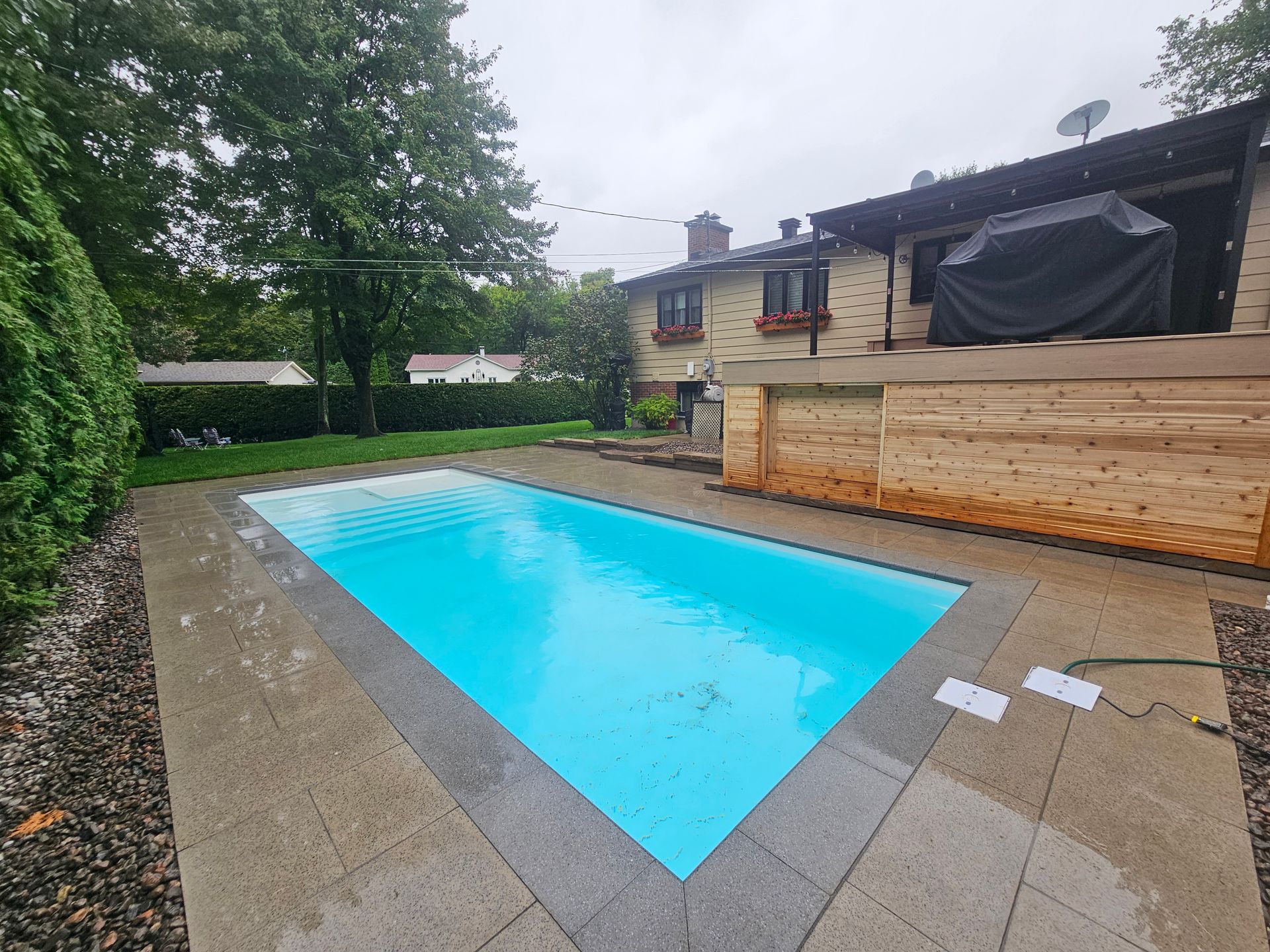 A large swimming pool in the backyard of a house