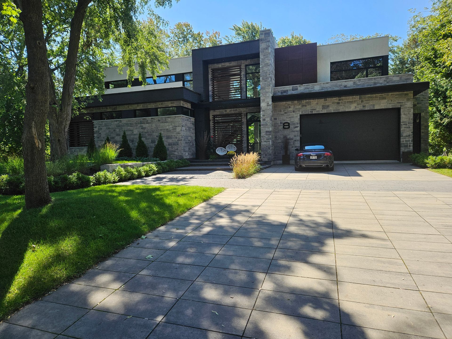 A large house with a car parked in front of it.
