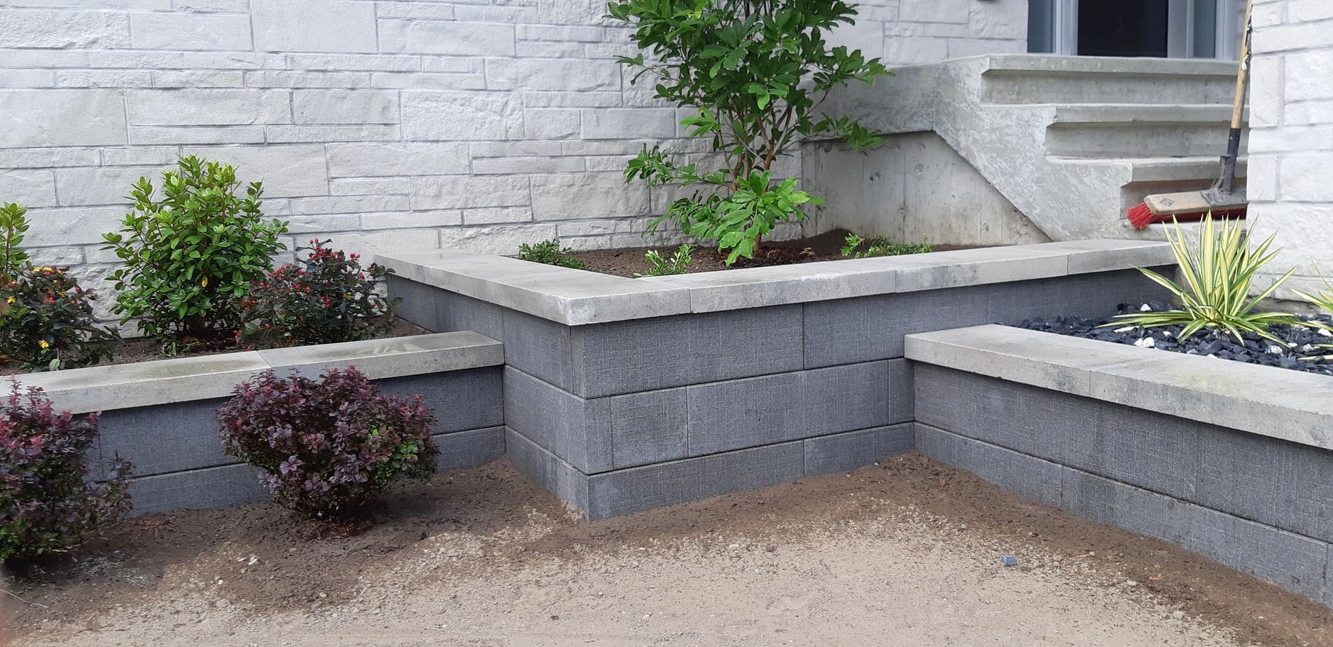 A brick wall with a planter in the middle of it