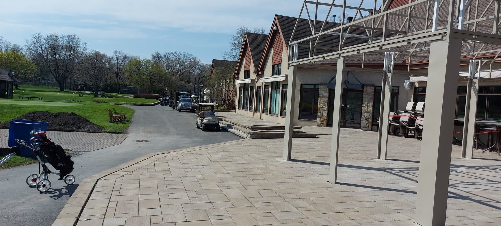 A person is walking down a sidewalk next to a building.