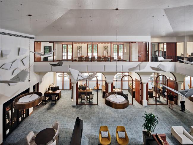 An aerial view of a hotel lobby with tables and chairs