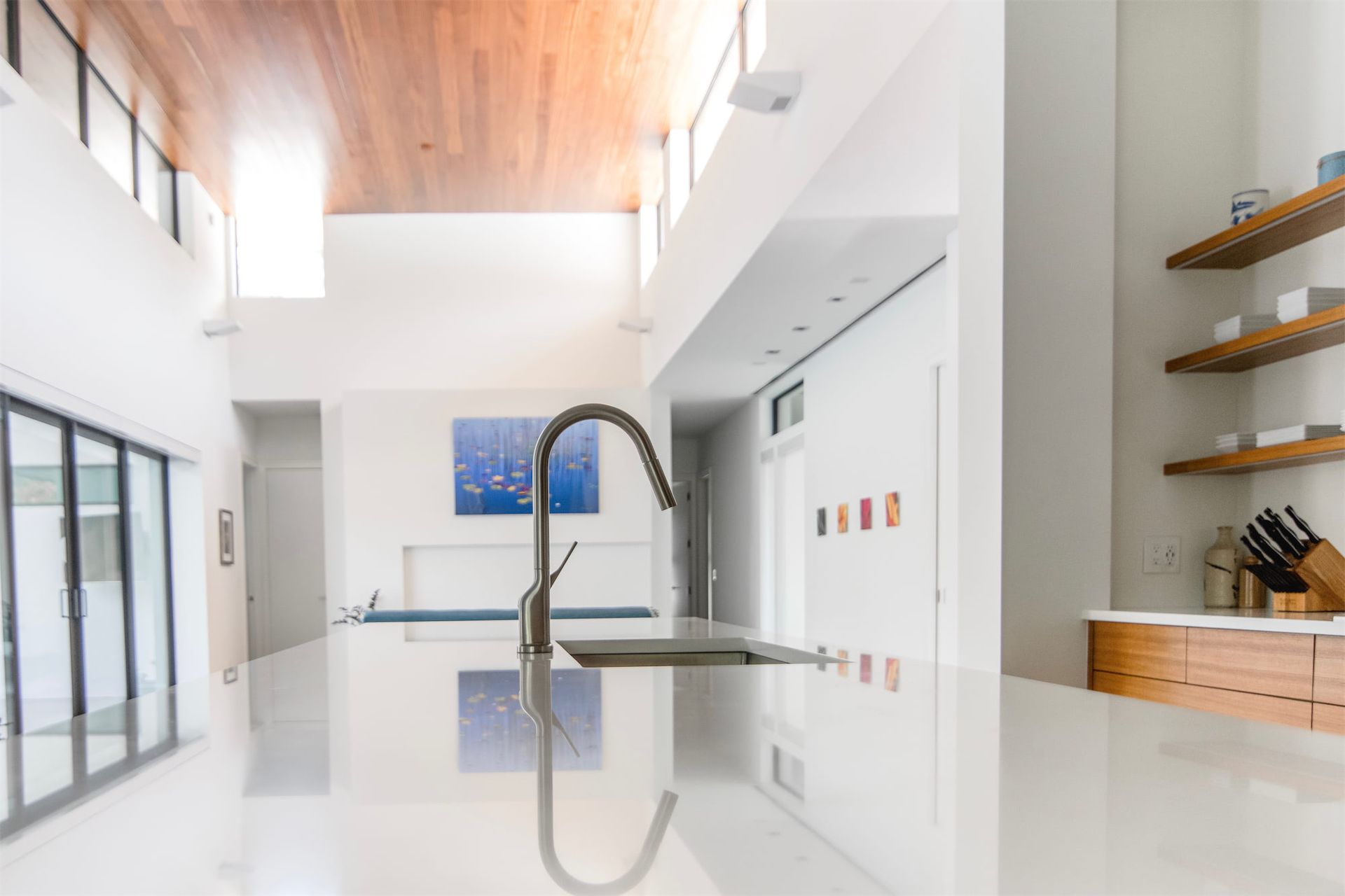 a kitchen with a sink and a painting on the wall