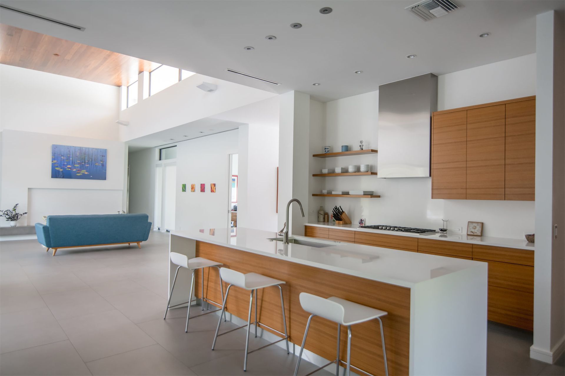 a kitchen with a blue couch in the background