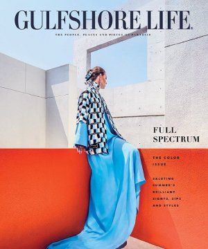 A woman in a blue dress is on the cover of a magazine.