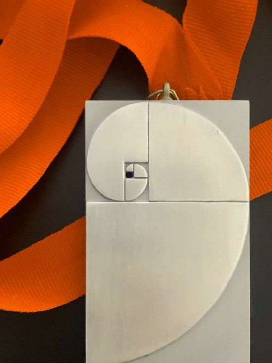 A white object with a golden spiral on it
