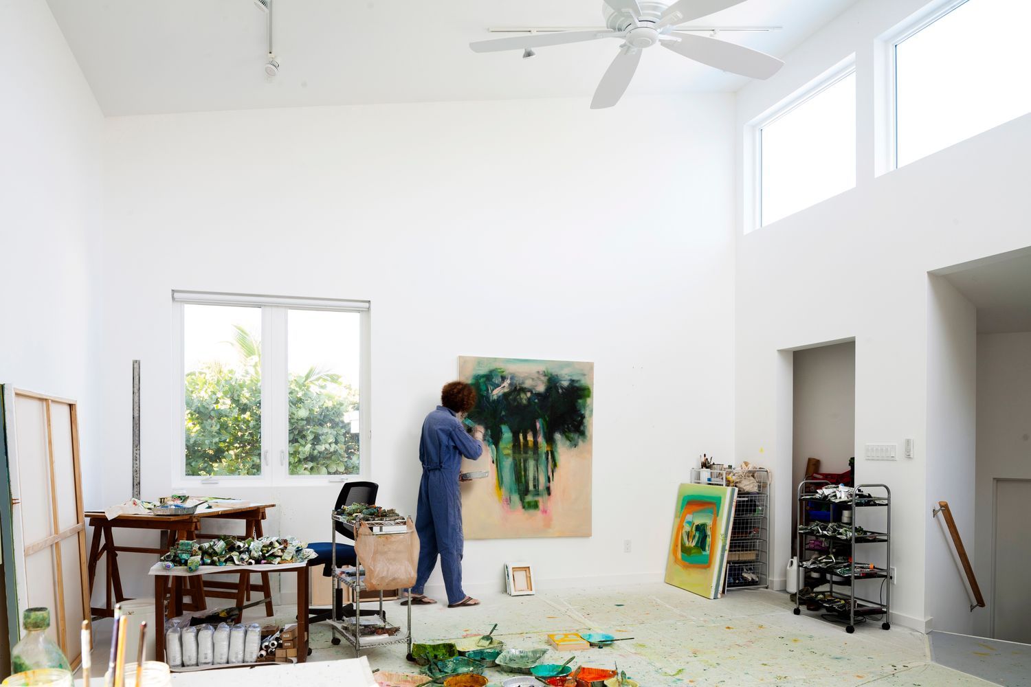 a person is painting a picture in an art studio