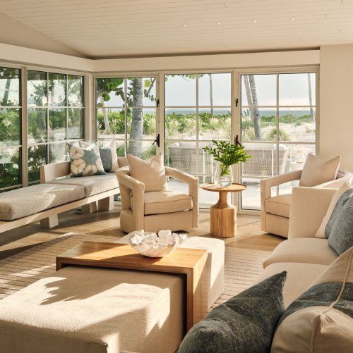 A living room with a couch and chairs and a table