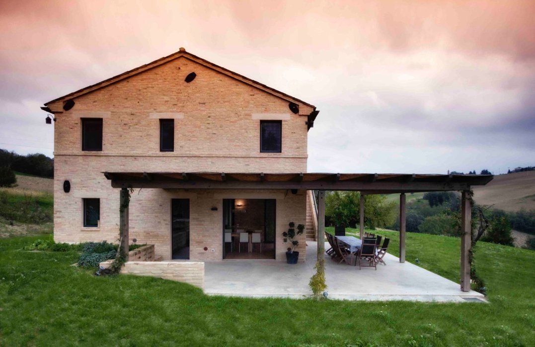 a large white house sits in the middle of a lush green lawn