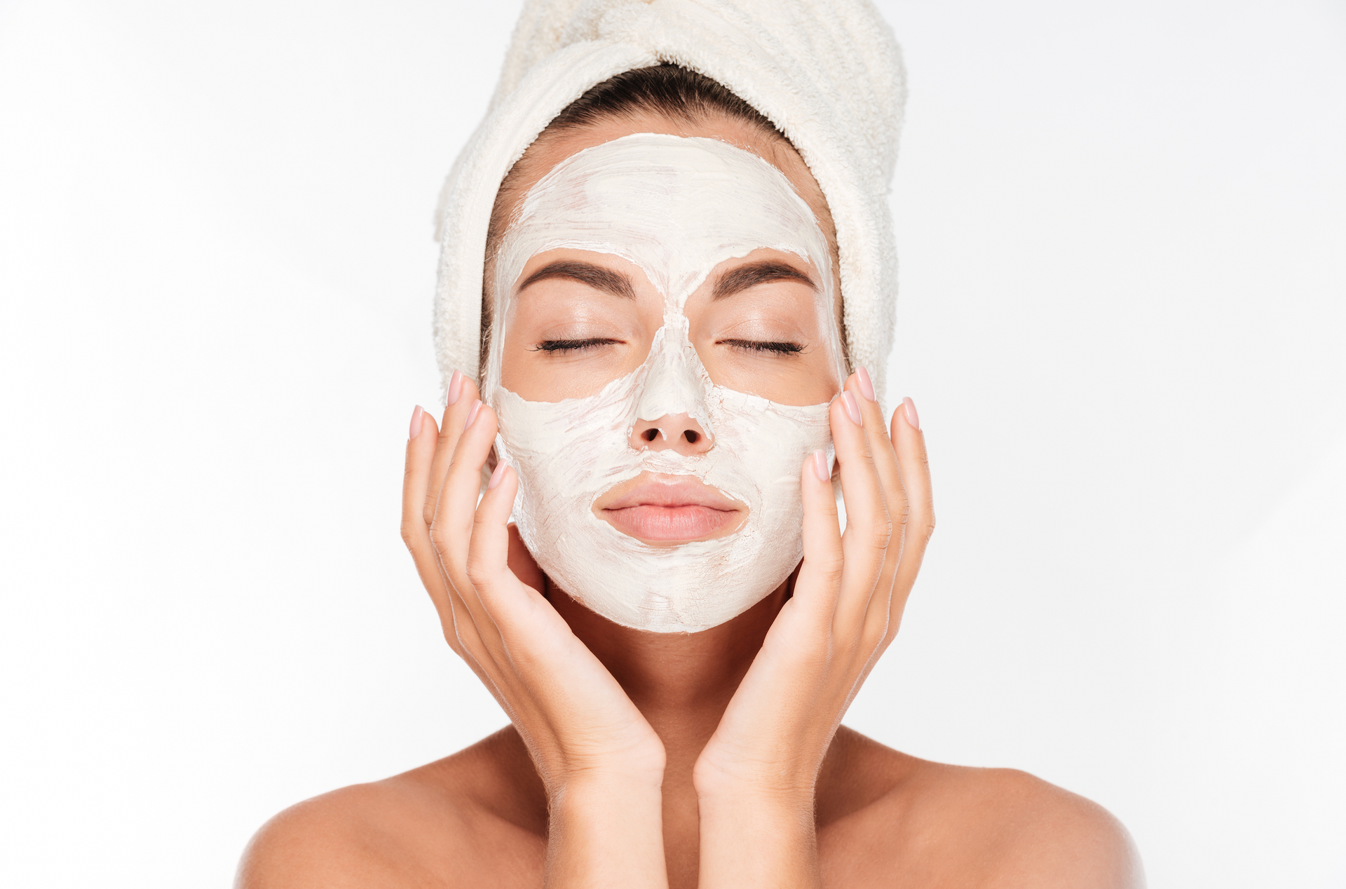 A Woman With A Towel Wrapped Around Her Head Is Wearing A White Mask On Her Face
