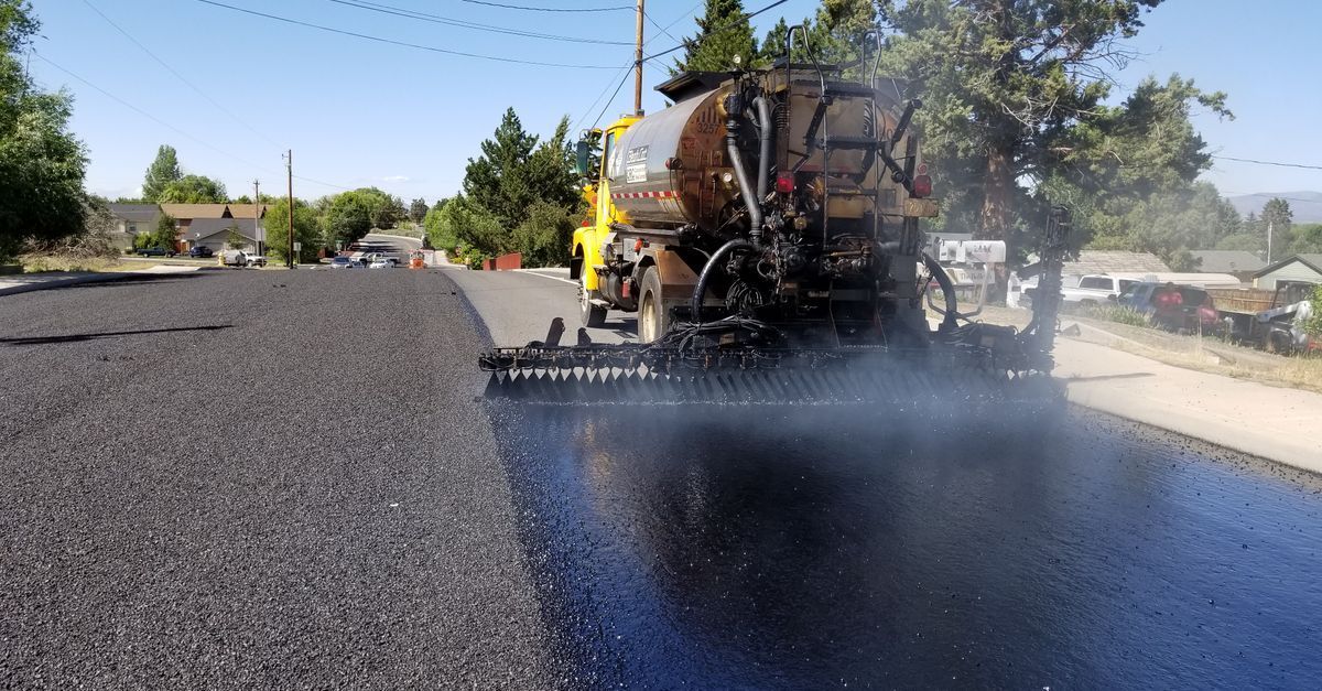 Freshly paved asphalt parking lot curing before reopening