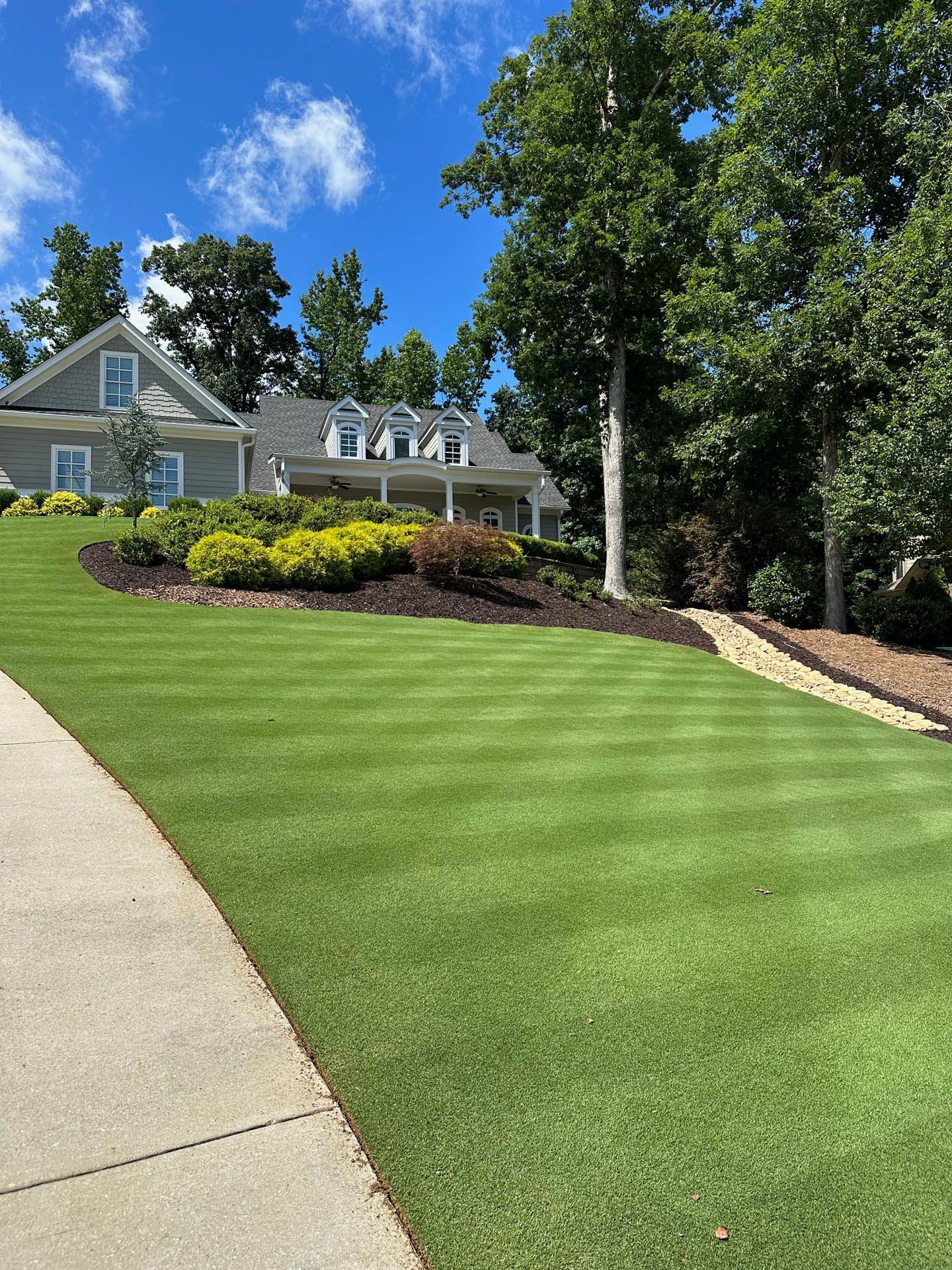 Lush green lawn with striped mowing pattern