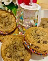 Chocolate chip cookie sandwiches with sprinkles, a clear drink cup that reads