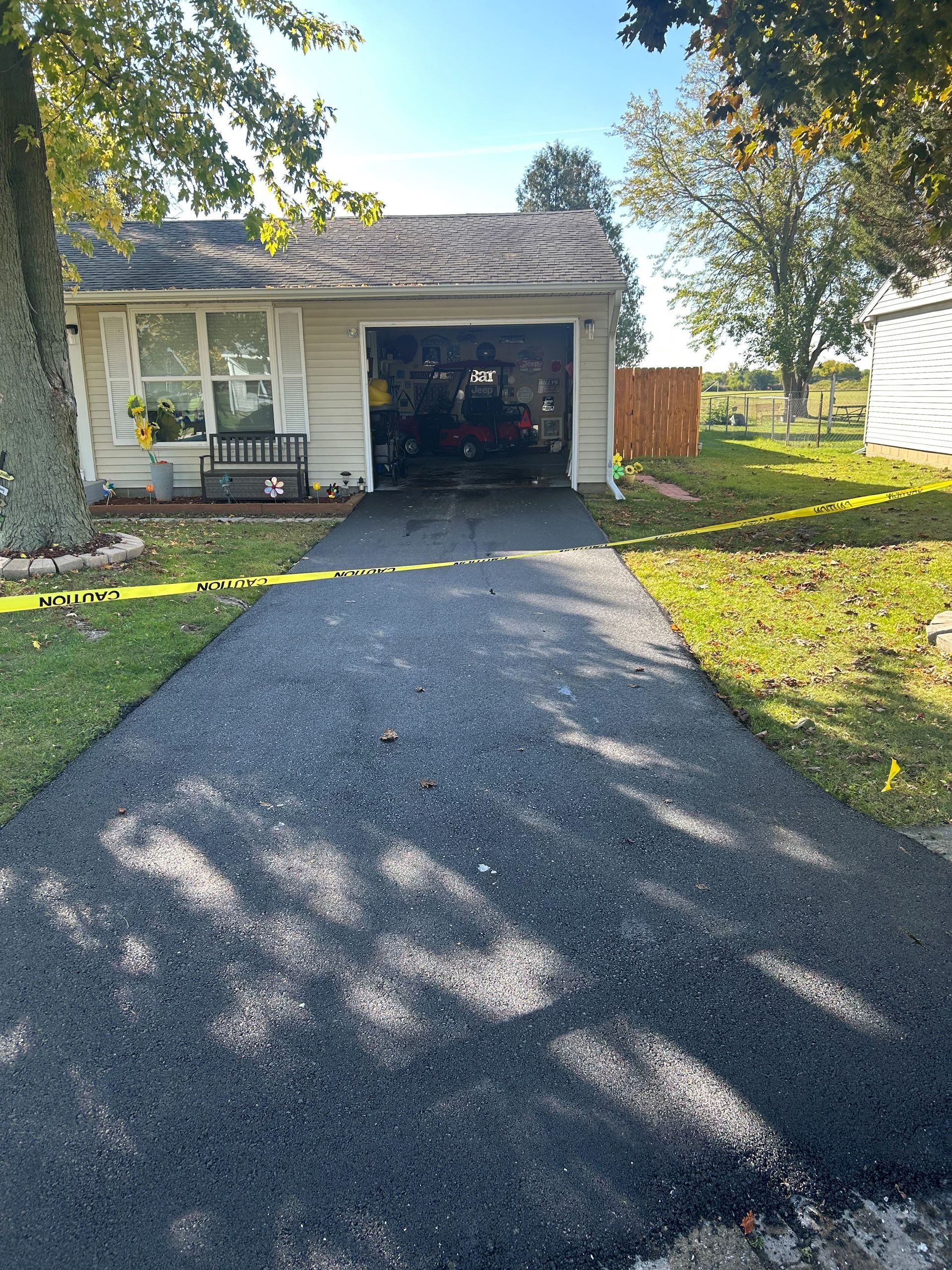 A driveway leading to a house with a garage.