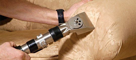 Using Vacuum On The Sofa — Cedar Rapids, IA — Eastern Iowa Carpet Care Inc