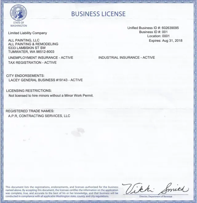 Business license document with blue seal and handwritten signature at bottom right.
