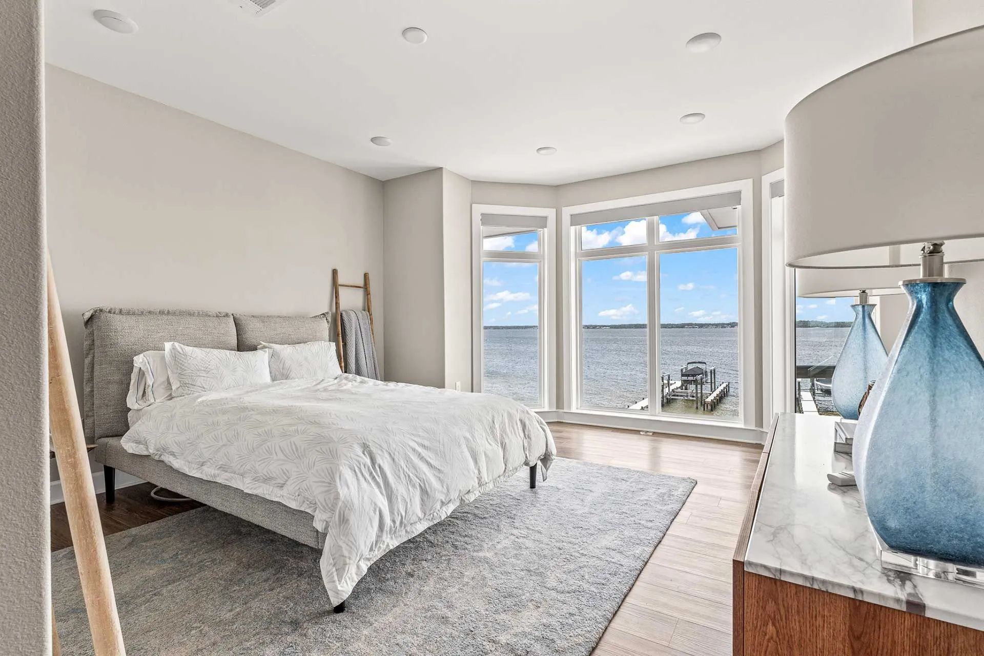 A bedroom with a large bed and a view of the ocean.