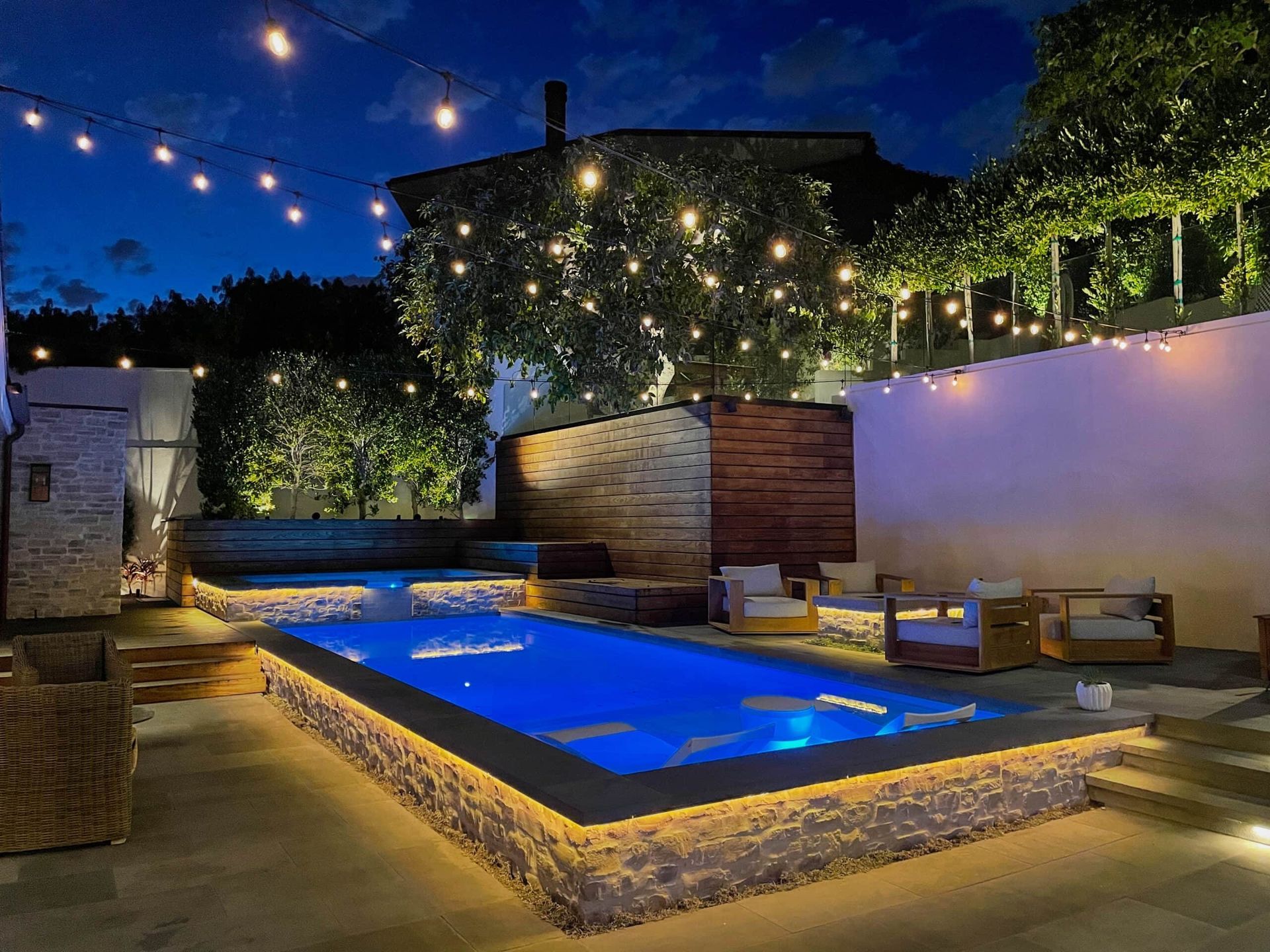 Pool with bistro lights overhead.