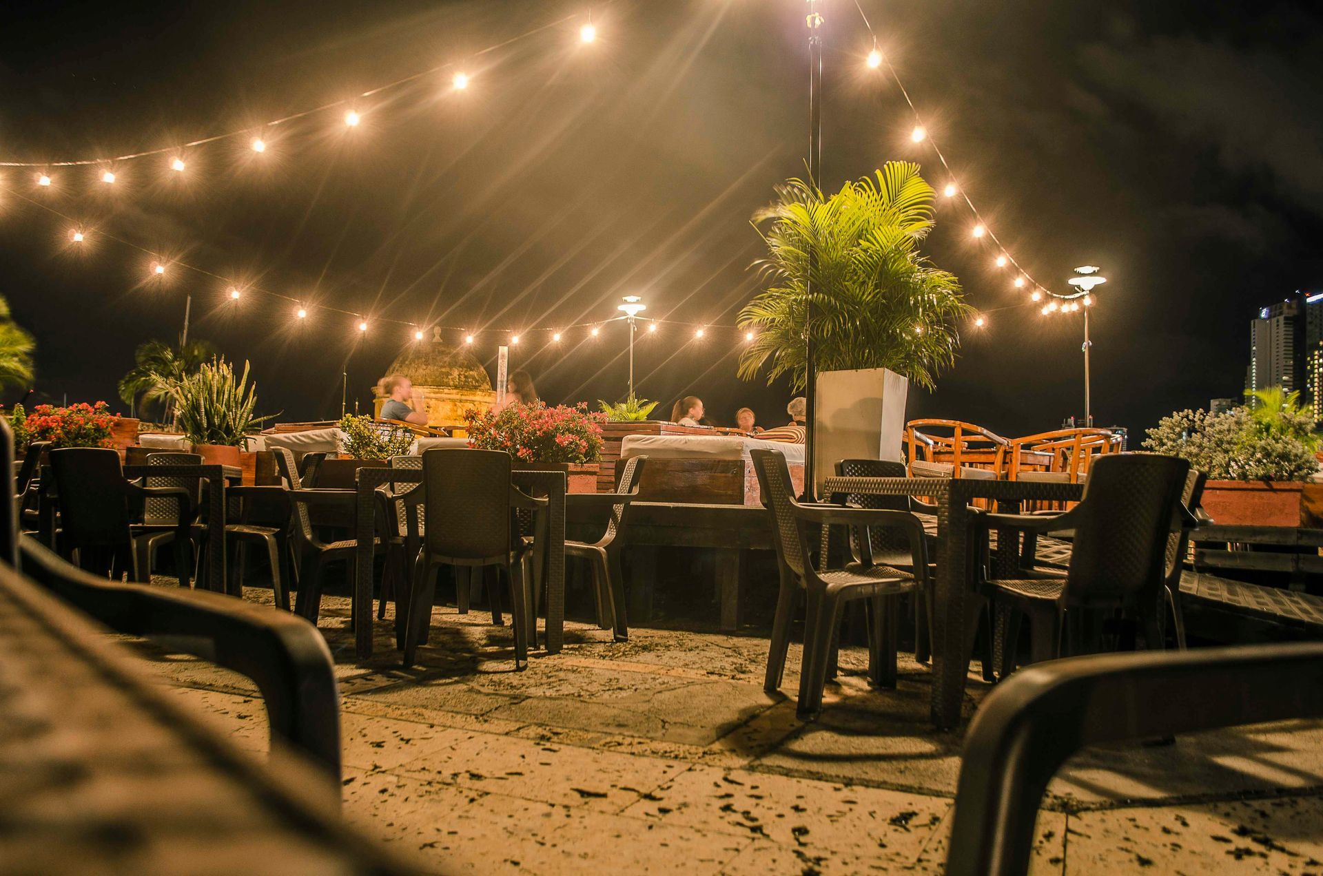 Seating area with dinner lights hung above.