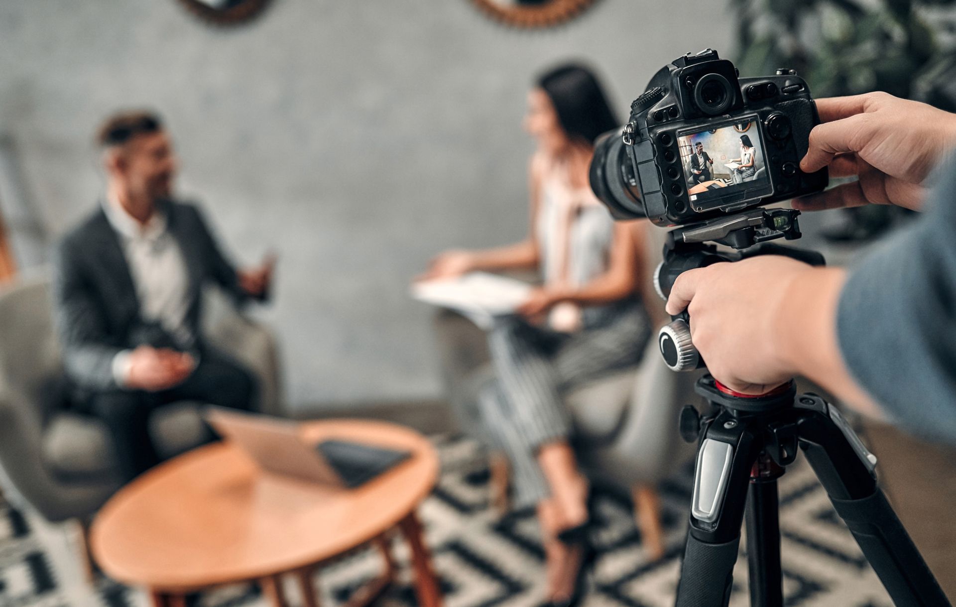 a man is holding a camera in front of a group of people