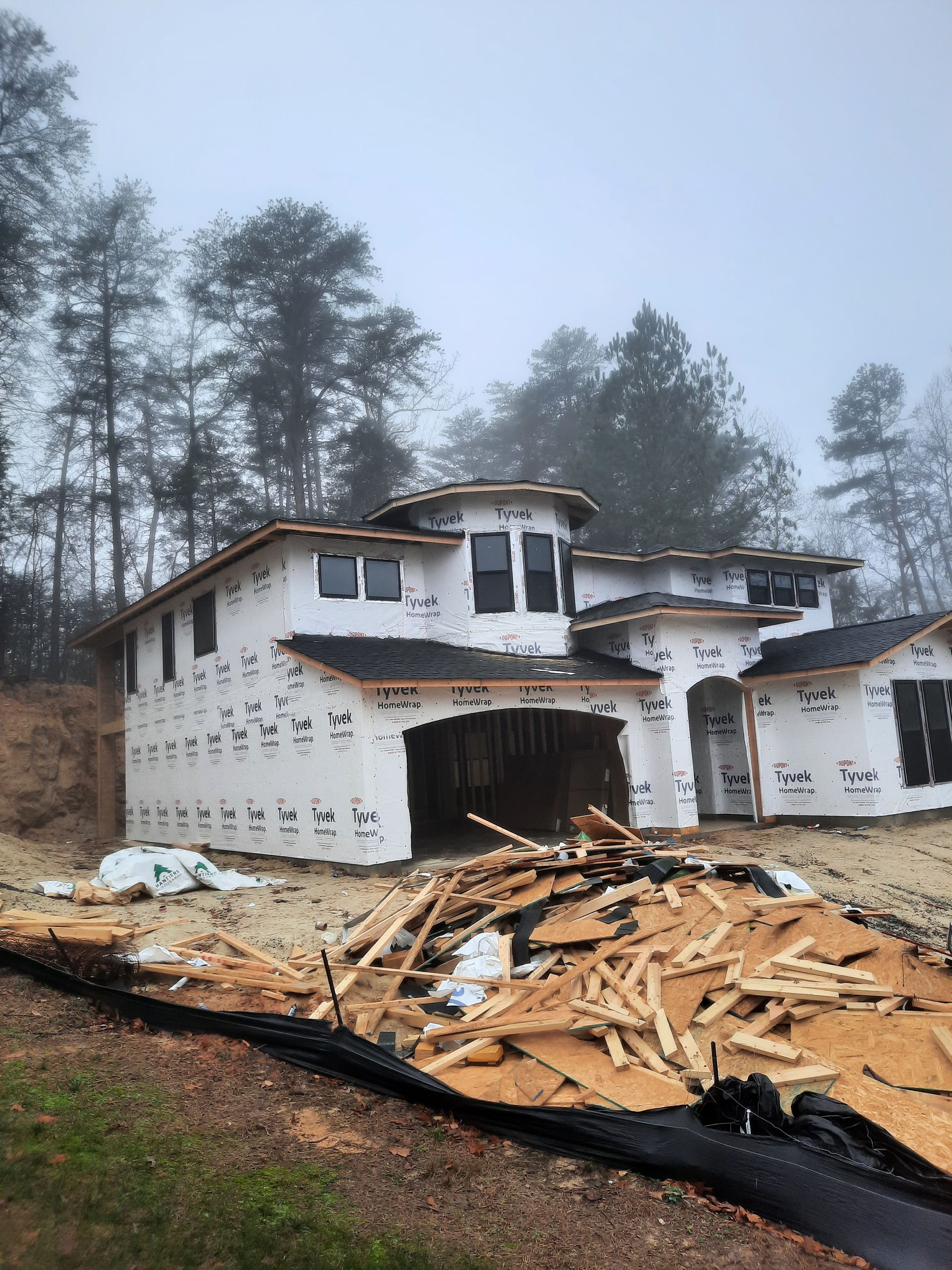 A large house is being built in the middle of a forest.