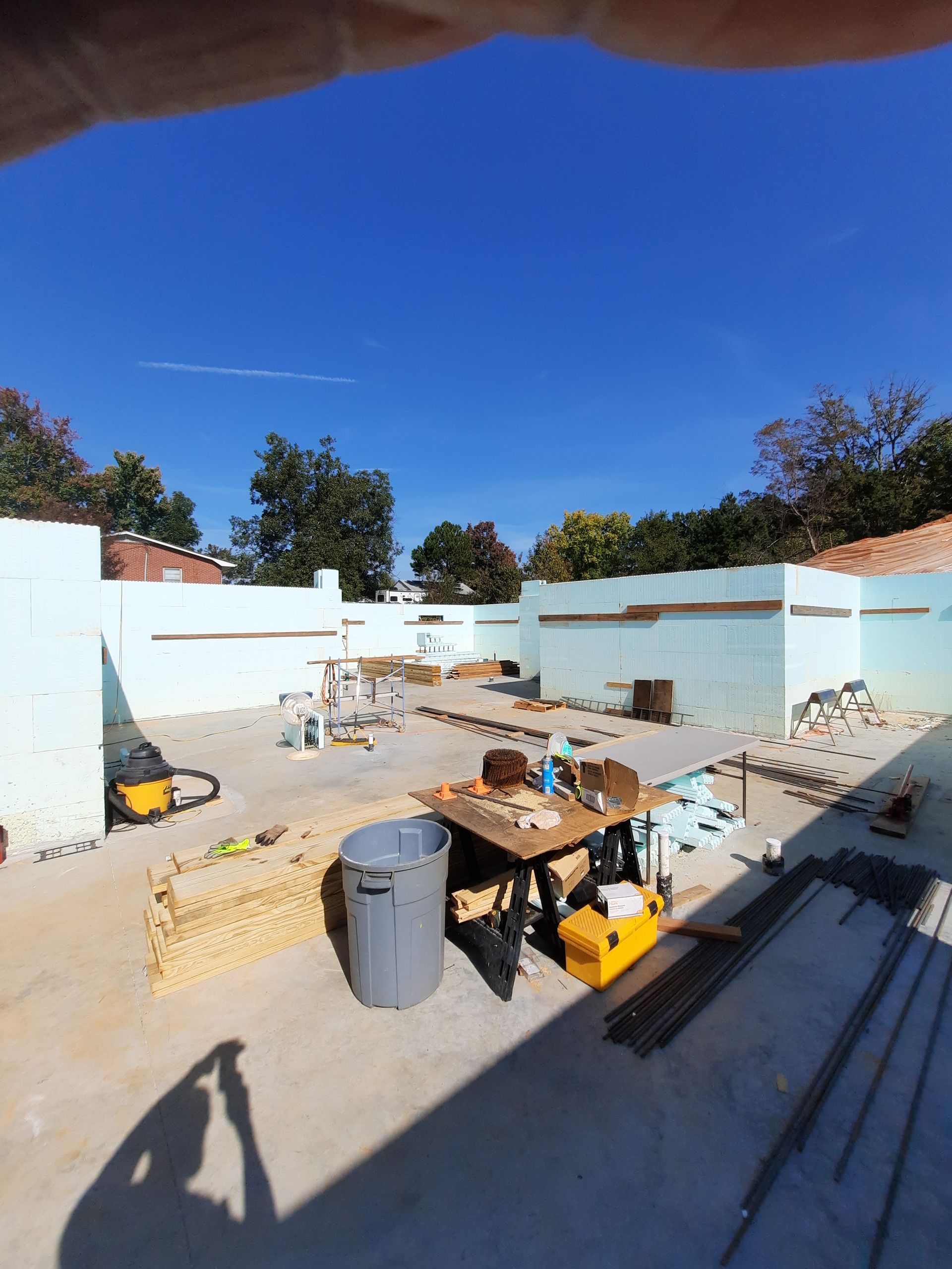 A person is taking a picture of a building under construction.