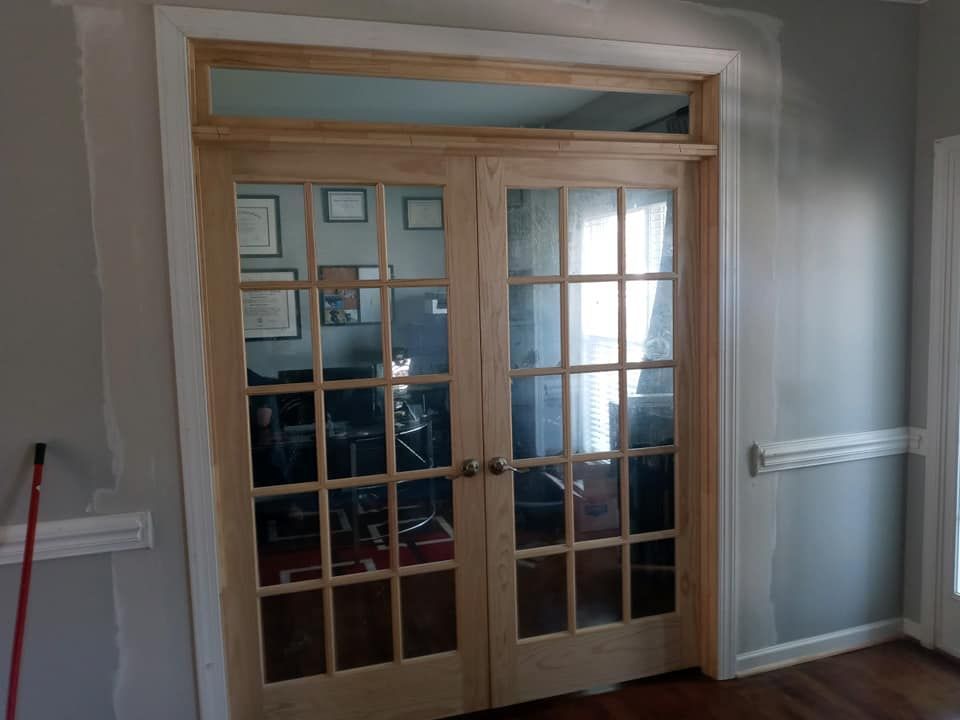 A pair of french doors leading into a living room