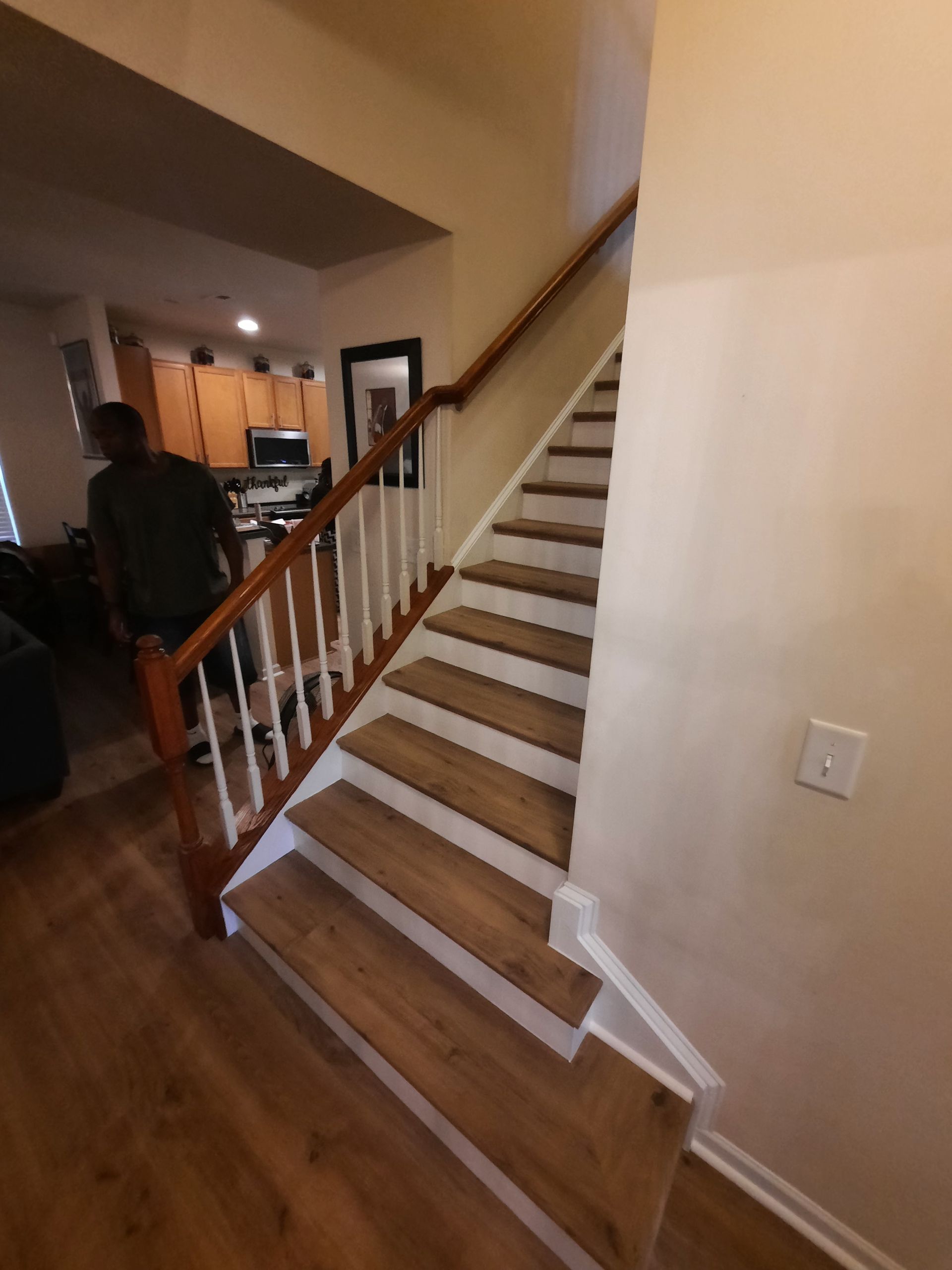 A man sits on the stairs in a house