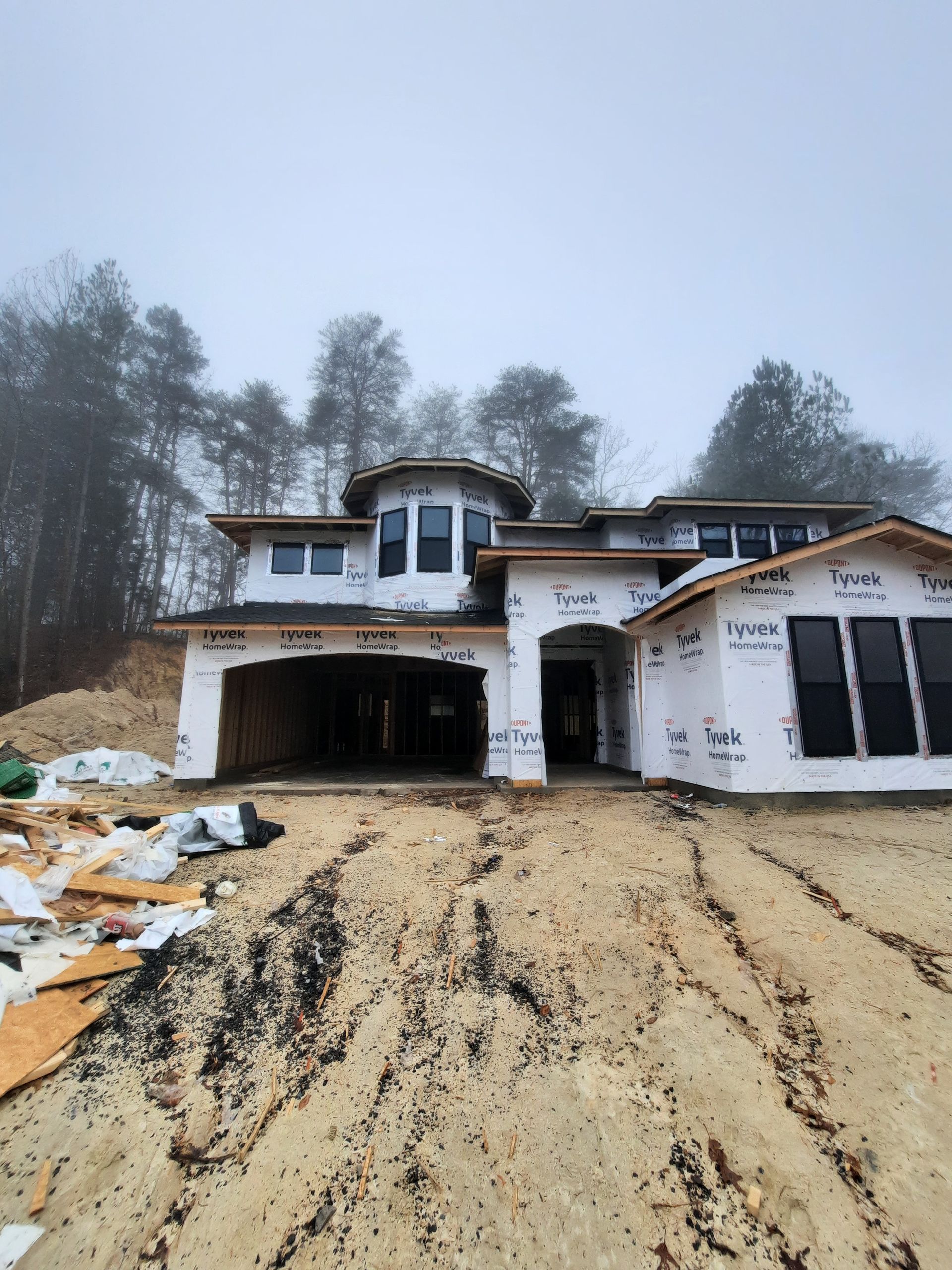 A house is being built in the middle of a dirt field