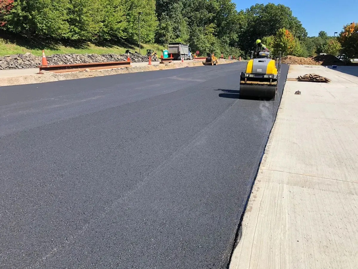 A road being paved with fresh black asphalt.