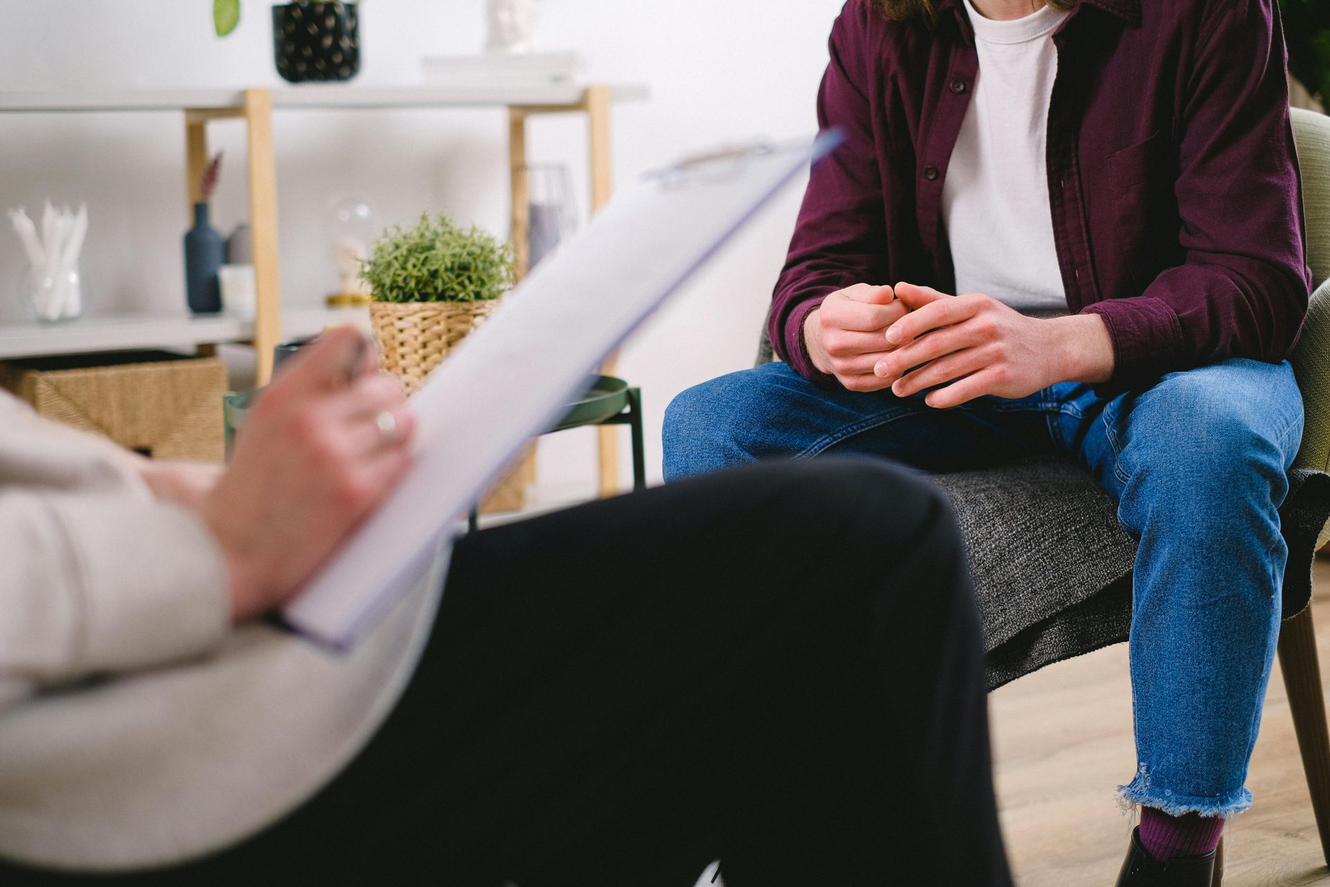 Therapist and client seated in a counseling session, with notes in the foreground.