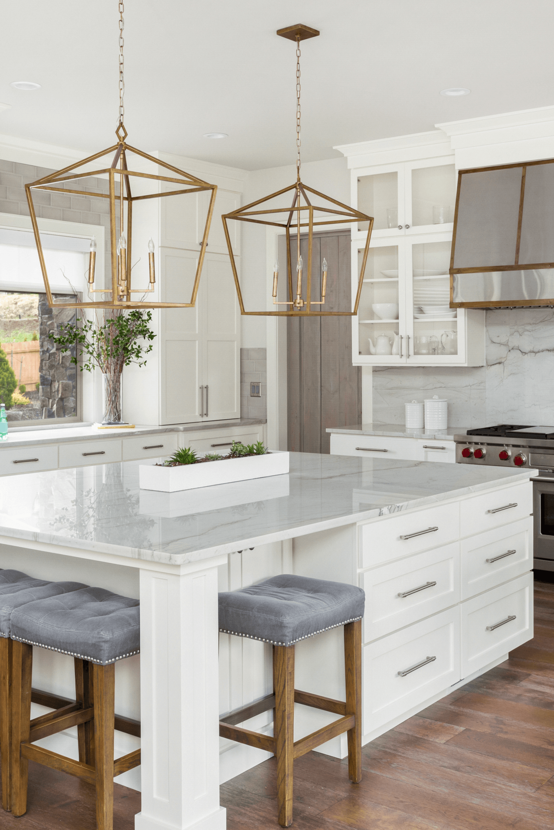 A kitchen with a large island and stools
