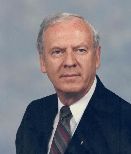 A man in a suit and tie is looking at the camera