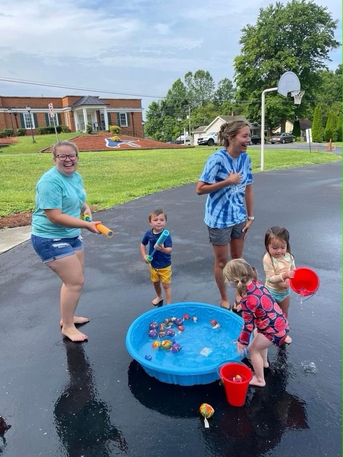A group of people are playing in a pool of water.