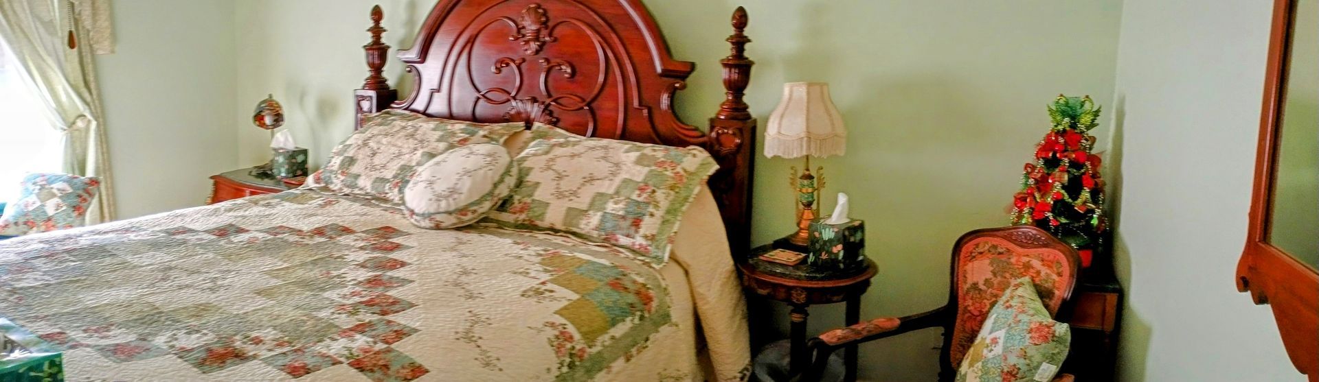 a bed with a quilt and pillows in a bedroom