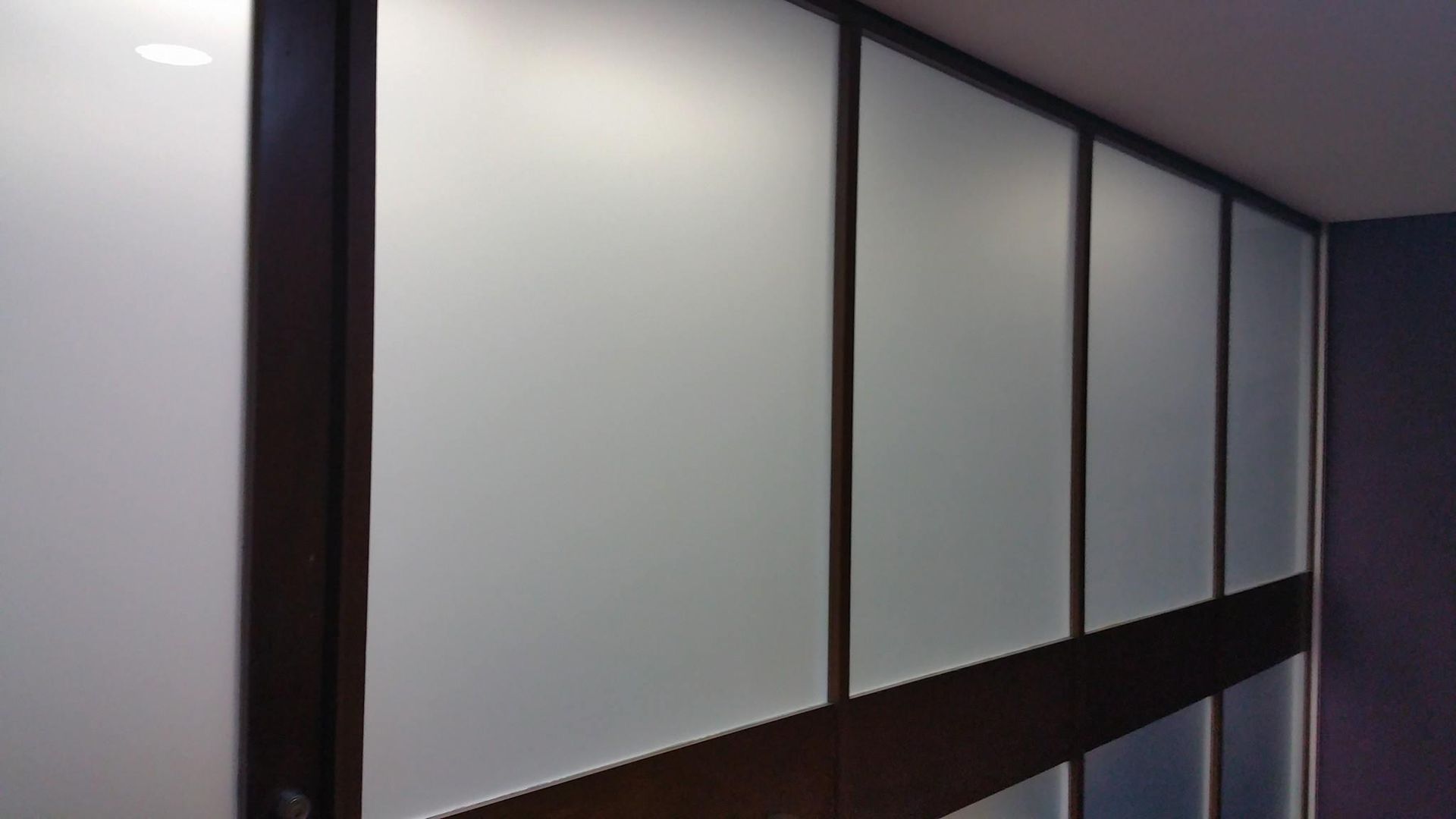 A Row of White Walls with Wooden Trim in A Room — Epic Window Tinting in Glenella, QLD
