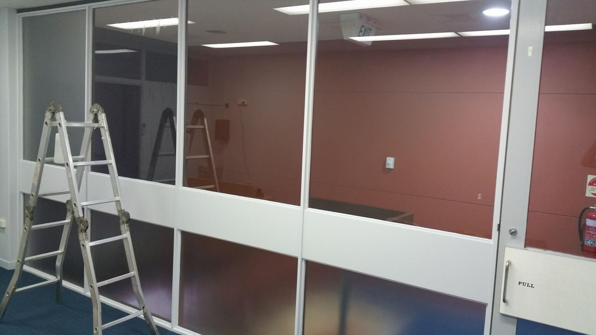 A Ladder Is Sitting Next to A Window in A Room — Epic Window Tinting in Glenella, QLD
