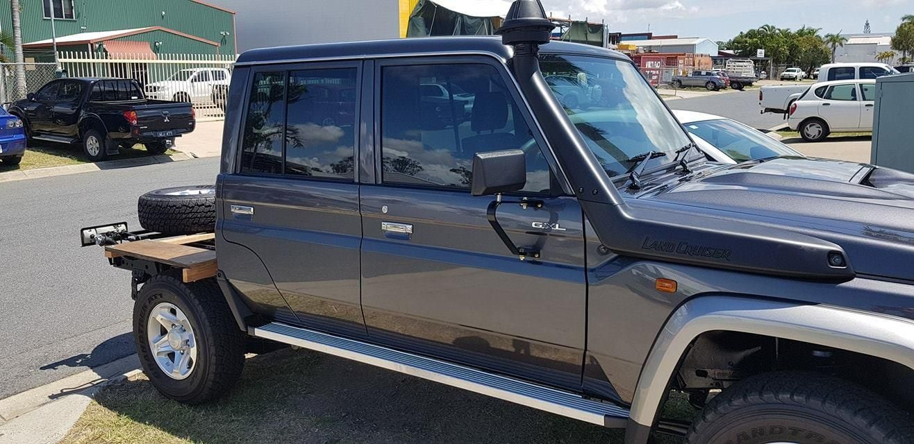 A Black Truck with a Snorkel on the Hood is Parked on the Side of the road — Epic Window Tinting in Glenella, QLD