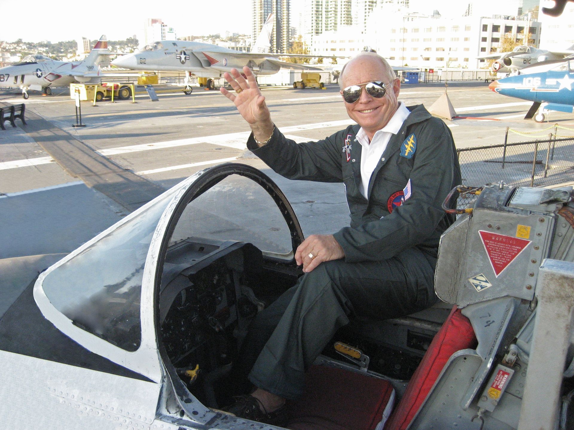 A man is sitting in the cockpit of an airplane