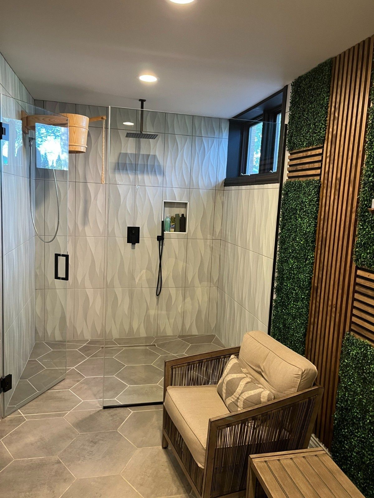 Modern shower room with gray tile, bench, and green wood slat accent wall